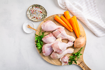 Image showing Raw chicken drumsticks with vegetables ans spices prepared for cooking