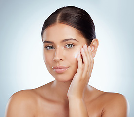 Image showing Skincare, face and beauty of woman with lotion in studio isolated on a white background. Portrait, dermatology cream and female model apply cosmetics, sunscreen or moisturizer product for skin health