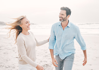 Image showing Love, happy and couple laughing on beach for holiday, vacation and weekend for anniversary. Travel, marriage and happy mature man and woman walking for bonding, quality time and happiness by ocean