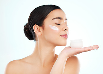 Image showing Skincare, face cream and woman with container in studio isolated on a white background. Lotion, dermatology product and female model with sunscreen, beauty cosmetics or smell healthy skin moisturizer