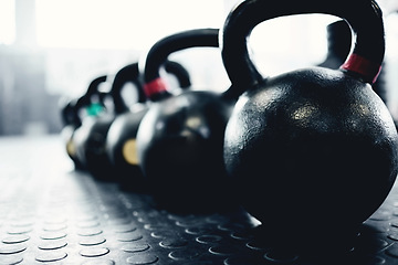 Image showing Fitness, weights and kettlebell on floor of gym for workout, strong and exercise. Metal, iron and performance with sports equipment in training center for weightlifting, wellness and challenge