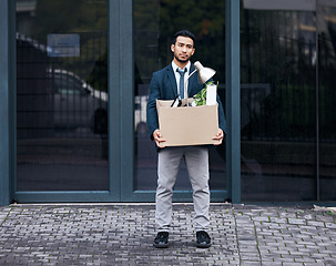 Image showing Depression, economy and box with a jobless business man walking outdoor in the city alone. Financial crisis, unemployment and fired with a young asian male employee looking sad in an urban town