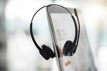 Image showing Technology, call center agent headset and computer for online communication with a lens flare. Customer service or crm equipment, telemarketing or consulting and tech support or sales at workplace