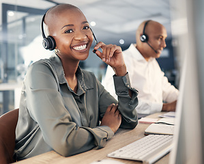 Image showing Consultant, woman call center agent with headset and computer for online communication at office. Customer service or crm , telemarketing or consulting and African female smile at her workstation