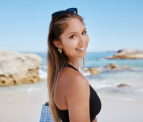 Image showing Woman, portrait and smile at beach with travel, summer tropical vacation in Mexico with tourism and adventure. Female person is happy, relax on holiday with journey to the ocean and seaside nature