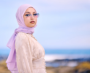 Image showing Portrait, fashion or sunglases with a muslim woman on mockup outdoor in a scarf for contemporary style. Islam, faith and hijab with an edgy young arab female person posing outside in modern eyewear