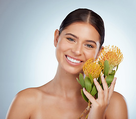 Image showing Face, skincare and happy woman with flowers in studio isolated on a white background. Portrait, natural and female model with floral pincushion protea plants for makeup, cosmetics or beauty treatment