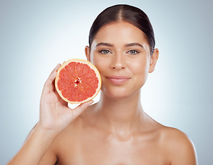 Image showing Skincare, face and woman with grapefruit in studio isolated on a white background. Portrait, natural fruit and female model with vitamin c, nutrition and healthy diet, wellness or beauty cosmetics.