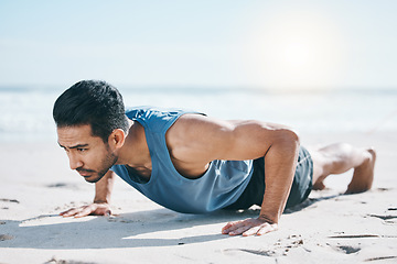 Image showing Man, beach and pushup on sand for workout, fitness or exercise for performance in summer sunshine. Young guy, bodybuilder and training for health, wellness and strong body with self care on ground