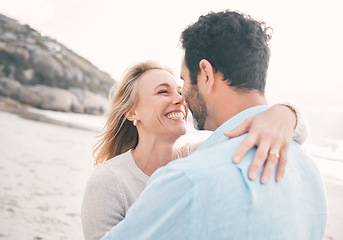 Image showing Love, happy and couple hug at beach for holiday, vacation and weekend getaway for anniversary. Travel, marriage and happy mature man hugging woman for bonding, quality time and happiness by ocean