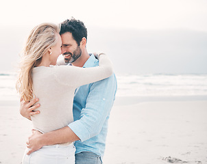 Image showing Travel, beach and couple touching forehead on holiday, vacation and weekend for anniversary. Intimacy, marriage and happy mature man hugging woman for bonding, quality time and happiness by ocean