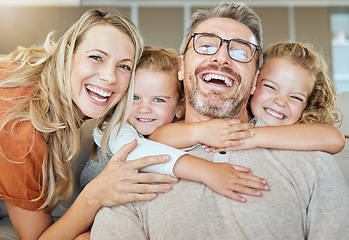 Image showing Parents, portrait and couch with hug, kids and smile with love, bonding and care in family home together. Father, mother and daughters with happiness, embrace and relax on living room sofa in house