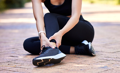 Image showing Woman with ankle pain, running injury and fitness with joint fracture, muscle inflammation and health problem. Female athlete injured on run outdoor, hands holding sore foot and healthcare emergency