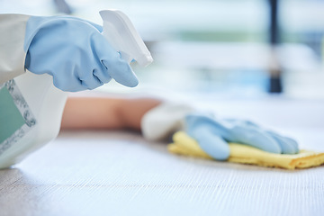 Image showing Hands, housekeeper and detergent for cleaning table, hygiene or bacteria and germ removal at home. Hand of person, cleaner or maid spraying and wiping furniture or surface for dust, dirt or stain