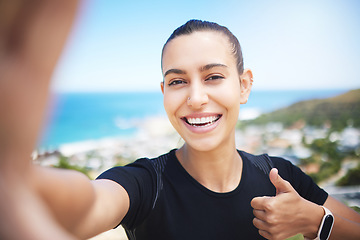 Image showing Runner woman, mountain selfie and fitness portrait with energy, smile and training for wellness on social media. Girl, influencer and profile picture with ocean, cityscape and thumbs up in summer