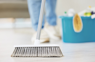 Image showing Cleaning, broom and sweeping with a maid in the living room of a home for housework or chores. Floor, sweep and housekeeper with a cleaner in a house to tidy for hygiene during a spring clean closeup