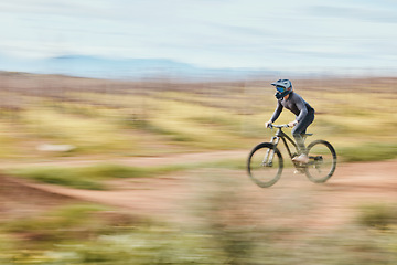 Image showing Fitness, adrenaline and man riding a bike in nature training for a race, marathon or competition. Sports, motion and male athlete biker practicing for an outdoor cardio exercise, adventure or workout