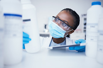 Image showing Stock check tablet, chemical bottle and black woman scientist with mask at pharmaceutical lab. Research, label reading and science of a female worker with manufacturing job and chemistry inventory