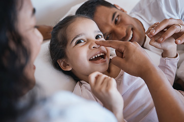 Image showing Smile, love and happy family in a bed laughing, bonding and playing in their home together. Face, playful and girl child with parents in a bedroom, having fun and enjoying a weekend in their house