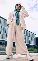 Image showing Portrait, city fashion or religion with a muslim woman outdoor in a cap and scarf for contemporary style. Islam, faith or hijab with a trendy young arab female person posing outside in urban clothes