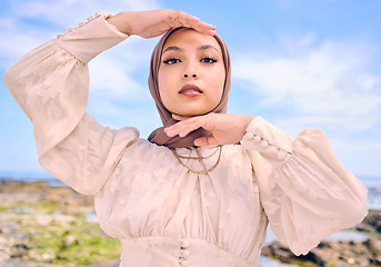 Image showing Portrait, hands or fashion with a muslim woman outdoor in a scarf for religion or contemporary style. Saudi, face and hijab with a trendy young islam female person posing outside in modern clothes