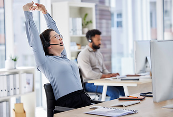 Image showing Customer service, woman with headset and stretching her arms at her desk with a computer of modern workplace. Online communication, telemarketing and female call center agent stretch for fatigue