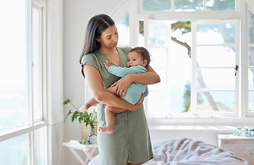 Image showing Mother, baby and holding kid in home for love, care and quality time together for childcare, growth and development. Mom, infant and carrying newborn girl in arms for support, comfort or nursery room