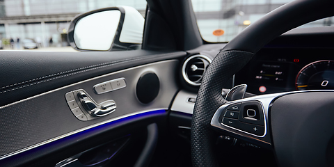 Image showing Control buttons on steering wheel. Car interior.