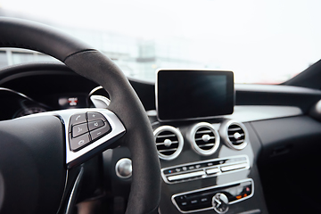 Image showing Control buttons on steering wheel. Car interior.