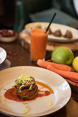 Image showing Baked vegetables in layers, fruits and carrot juice