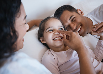 Image showing Love, smile and happy family in a bed laughing, bonding and playing in their home together. Face, playful and girl child with parents in a bedroom, having fun and enjoying a weekend in their house