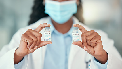 Image showing Doctor hands, covid and black woman with vaccine vials for virus or corona. Bottles, medical professional and person with vaccination mask, medicine or pharmaceutical drugs for healthcare at hospital