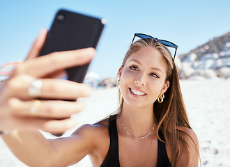 Image showing Young woman, beach selfie and smile with beauty, outdoor and summer vacation in sunshine for blog. Girl, happy influencer and photography for travel, social media and sea holiday in Rio de Janeiro