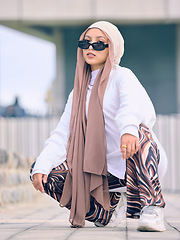 Image showing Portrait, fashion or religion with a muslim woman in the uae wearing a hijab and scarf for contemporary style. Islam, faith and burka with a trendy young islam person outside in traditional clothes