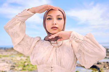 Image showing Portrait, hands or fashion with an islam woman outdoor in a hijab for religion or contemporary style. Islam, faith or headscarf with a trendy young arab female person posing outside in modern clothes