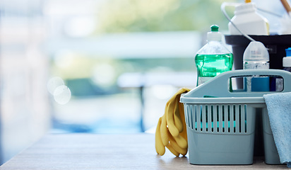 Image showing Basket, table and product for cleaning with space, cloth and chemical for mockup by blurred background in home. House, mock up and plastic container for services, stop bacteria and dust in interior