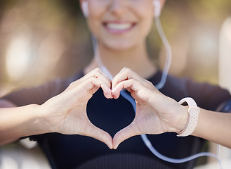 Image showing Healthy, heart hands or happy girl runner in park for fitness, exercise or workout for cardiovascular health. Love sign, hand gesture or blurry sports woman in sports training for wellness in nature