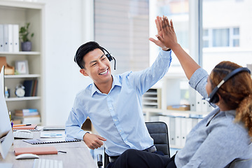 Image showing Call center, high five and team celebrate success at desk with headset for telemarketing teamwork. Asian man and a woman agent excited for sales deal, customer service, bonus achievement and target