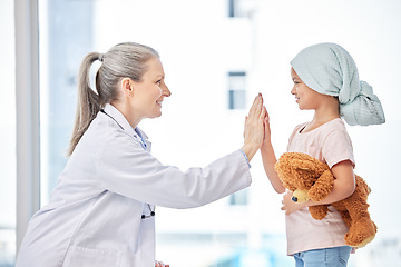 Image showing Cancer, child and doctor high five in support, healthcare service and success or empathy, love and healing in hospital. Happy girl or sick kid and pediatrician or medical woman help or hands together