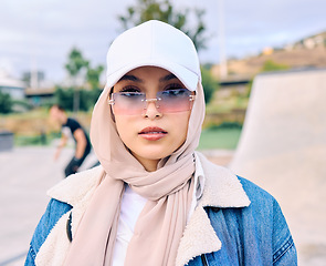 Image showing Portrait, fashion or sunglasses with an arab woman outdoor in a cap and scarf for contemporary style. Islam, faith and hijab with a trendy young muslim female person posing outside in modern eyewear