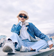 Image showing Portrait, fashion and Islamic woman in a city, sunglasses and trendy with a hijab, stylish outfit or gen z. Face, Muslim female person or confident girl outdoor with casual clothes, beauty or eyewear