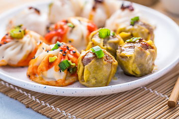 Image showing Assortment of steamed dumplings Dim Sum on kitchen table