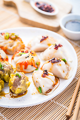 Image showing Assortment of steamed dumplings Dim Sum on kitchen table