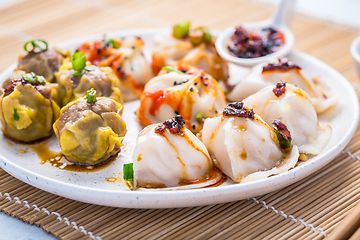 Image showing Assortment of steamed dumplings Dim Sum on kitchen table