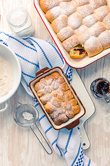 Image showing Sweet rolls, Buchteln (buchty) filled with plum jam or jelly with backing ingredients