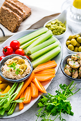 Image showing Summer crudites platter with hummus and avocado dip