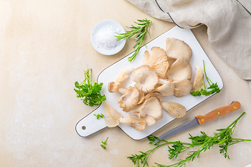 Image showing Fresh  organic oyster mushrooms on white chopping board with par