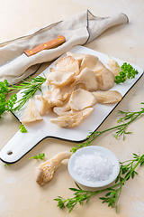 Image showing Fresh  organic oyster mushrooms on white chopping board with par