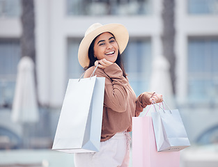 Image showing Happy woman in portrait, shopping bag and retail at outdoor mall, smile with purchase, luxury and shop discount. Female customer, fashion designer brand and buyer choice with store promotion and sale