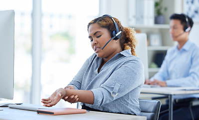 Image showing Call center, wrist pain and woman in office suffering carpal tunnel while working in customer service. Hand, injury and lady consultant with arthritis, osteoporosis or muscle weakness in crm or faq